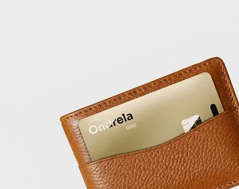 Cartão Ondrela dourado na ranhura de uma carteira de couro